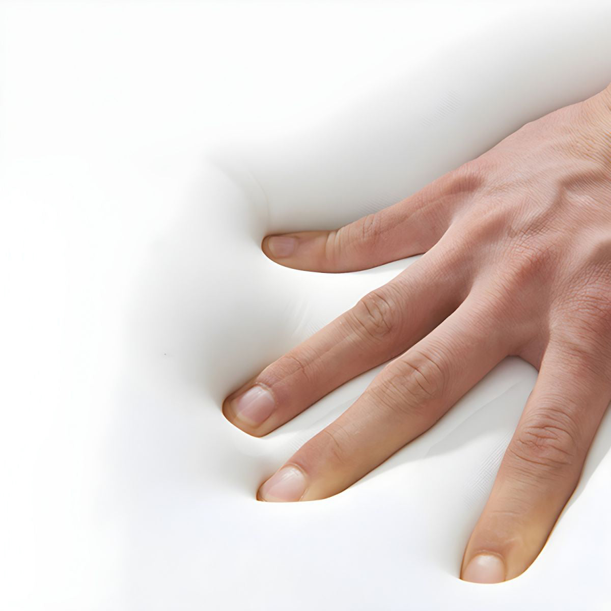 A hand presses on a white memory foam surface in The St. Tropez Collection by Landmark Decor, creating an indentation that highlights the foams ability to mold to shapes—perfect for crafting flexible, weather-resistant alfresco dining furniture.