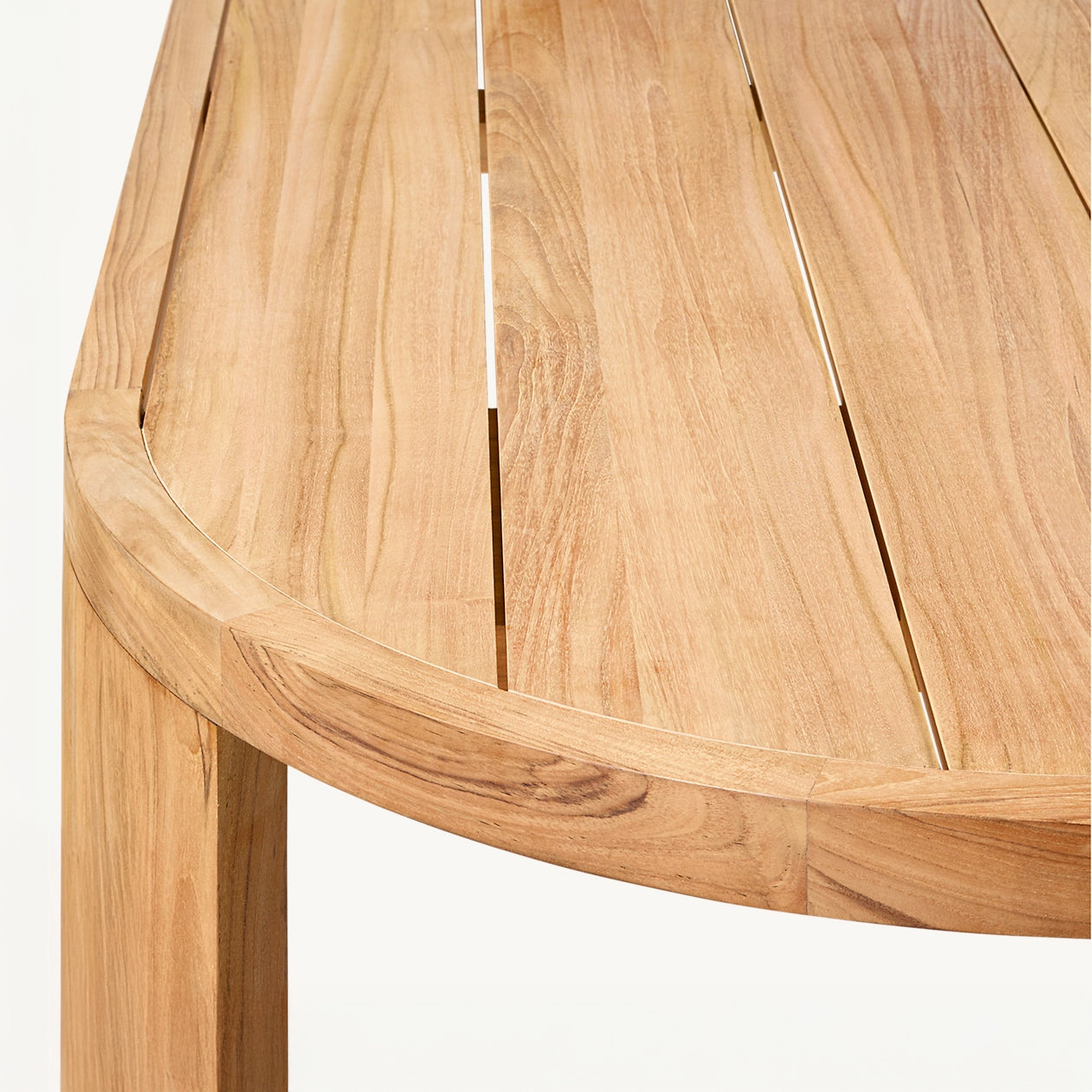 The Landmark Decor Pacific Shoreline Collection features a rounded wooden table perfect for alfresco dining. It boasts a smooth, natural finish with parallel slats to highlight the grain and texture. Crafted from weather-resistant materials, it adds a cozy feel to any outdoor setting.