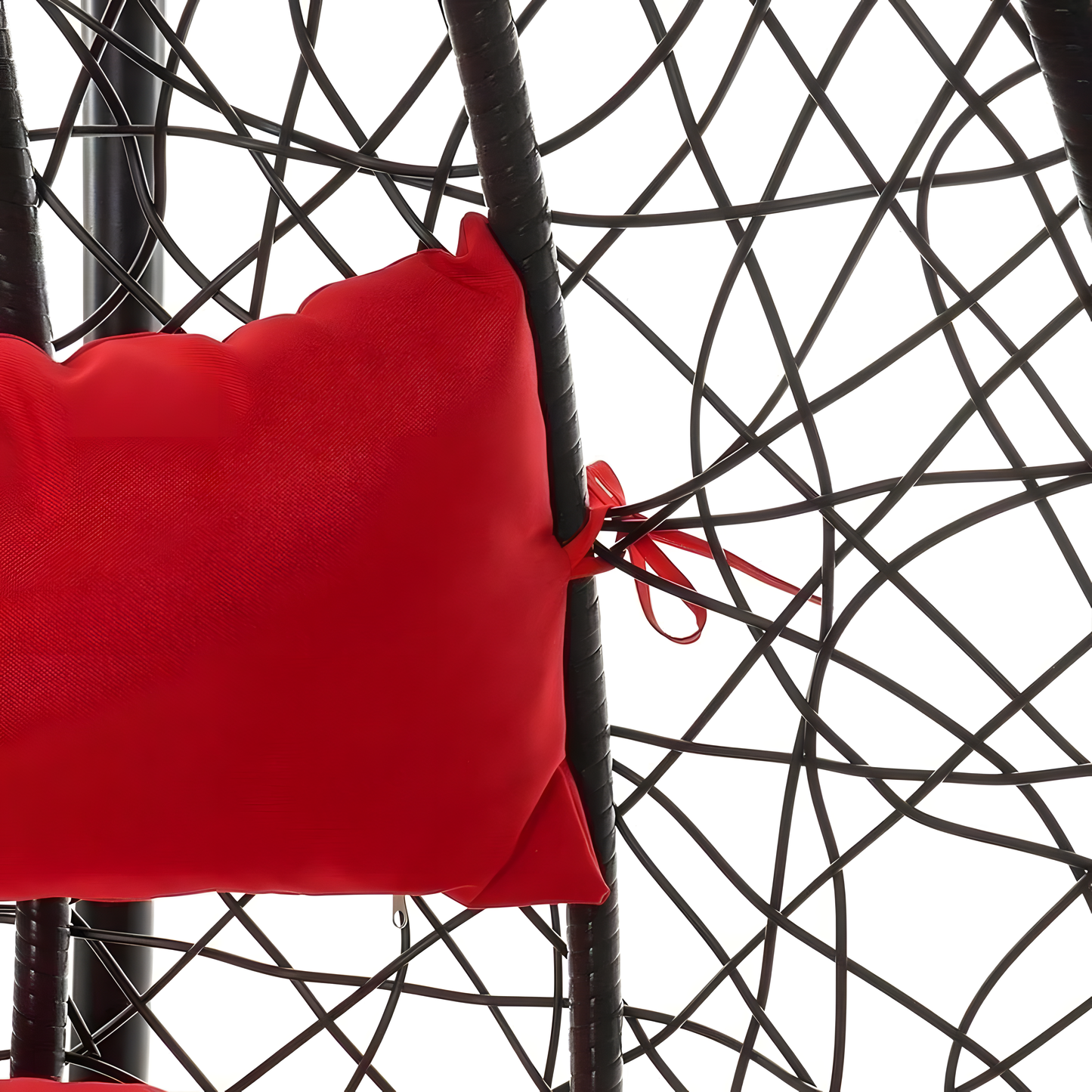 The Chelo Outdoor Swing Chair - Black by Landmark Decor, crafted from premium materials, features a vibrant red cushion with tied corners, offering a contrasting and inviting spot. Its intricate pattern stands out against a white background, epitomizing luxury and innovation.
