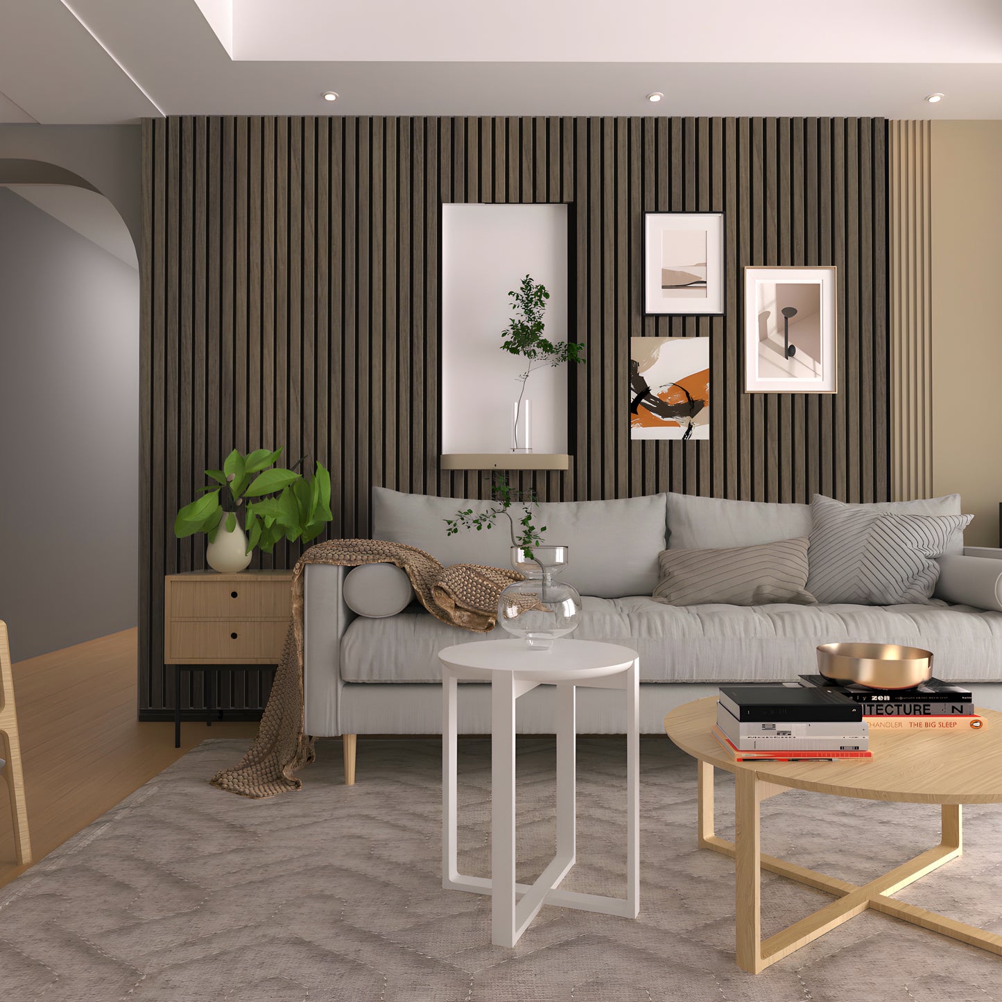 Modern living room featuring a gray sofa, decorative pillows, round tables, potted plants, and framed art displayed on Landmark Decor Cassia Wood Texture WPC Fluted Slat Wall Panels for a stylish accent backdrop.