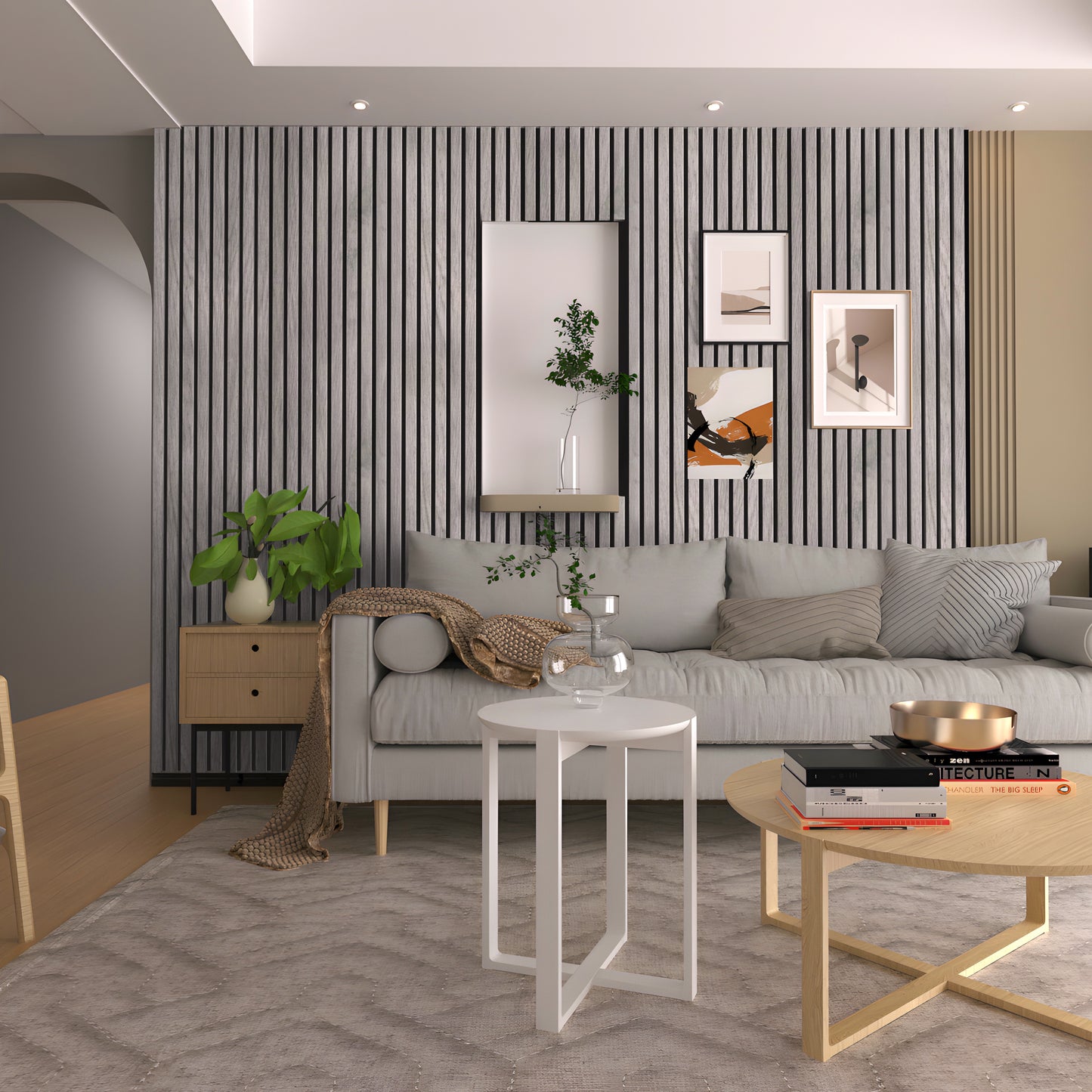 Modern living room with a gray sofa, framed art, potted plants, and round coffee tables on a textured rug. The striped accent wall features Landmark Decor’s Light Driftwood Texture WPC Fluted Slat Wall Panel for added style.