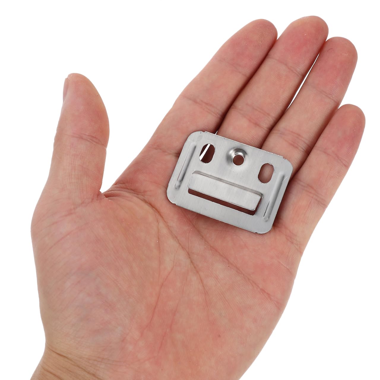 A hand holds a Landmark Decor Interior WPC Panel Clip, a small rectangular metal piece with multiple holes and slots, designed for secure fastening during wall panel installation.