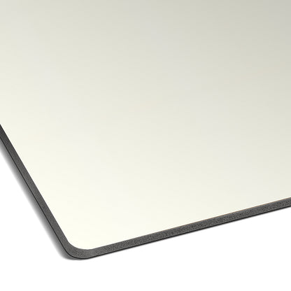 A close-up of the Landmark Decor Alabaster White Carbon Sheet shows its thin, rectangular form with a dark edge and rounded corners, set against modern wall panels for a sleek, contemporary vibe.