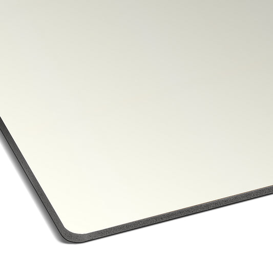 A close-up of the Landmark Decor Alabaster White Carbon Sheet shows its thin, rectangular form with a dark edge and rounded corners, set against modern wall panels for a sleek, contemporary vibe.