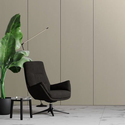 Modern minimalist interior featuring Landmark Decor's Warm Greige Carbon Sheet wall panels, a black swivel armchair, potted plant, glass side table, and white marble floor.
