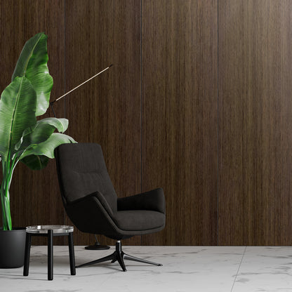 An Espresso Walnut Carbon Sheet from Landmark Decor creates a sleek, contemporary backdrop for a black swivel chair, glass side table, and potted plant set on a white marble floor with modern wall panels.