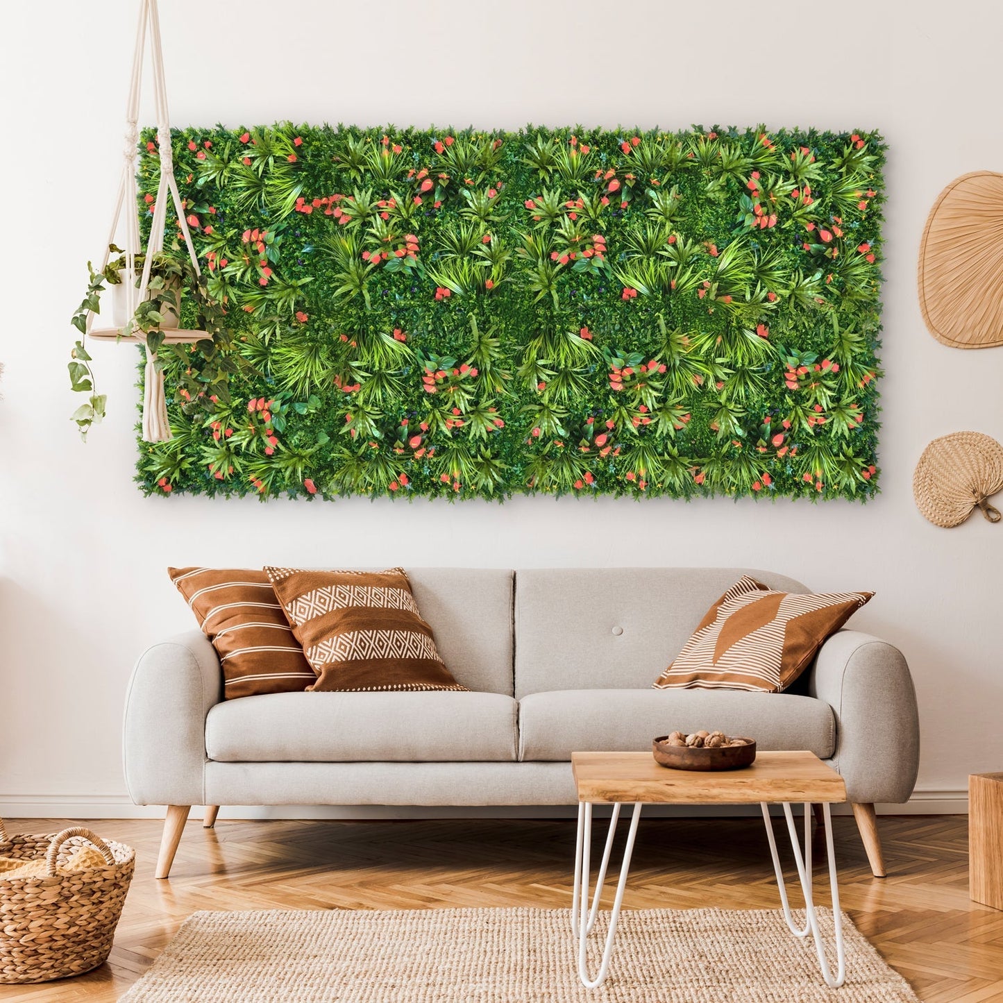 A modern living room featuring a light gray sofa, patterned cushions, a wooden coffee table, and the Landmark Decor Tropical Floral Wall with Red Flower Grass accents hanging above the sofa.