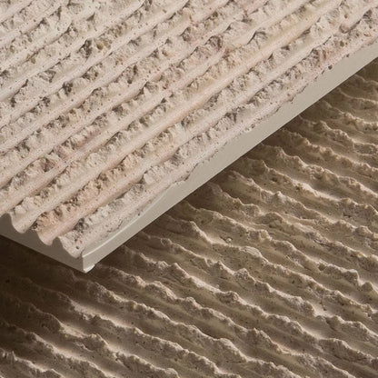 A close-up of two grey, textured Oman Linear Stone Sheets by Landmark Decor, featuring parallel ridges and a natural stone finish, with one sheet stacked slightly above the other.