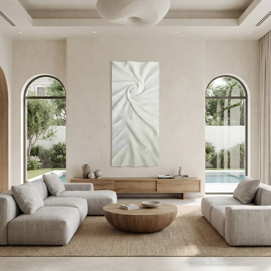 Minimalist living room with neutral-toned furniture, round wooden coffee table, luxury touches, arched windows, and a view of the pool and garden. Features Nova Wall Art - Small by Landmark Decor as standout abstract artwork.