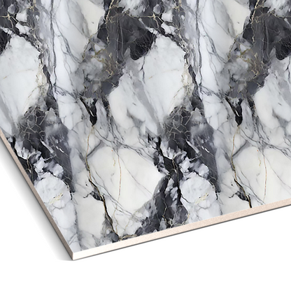 A close-up of Landmark Decor’s Shadow Storm Marble Durable PVC Wall showcases a black, white, and gray veined marble pattern with irregular shapes—ideal for creating decorative or striking accent wall panels.