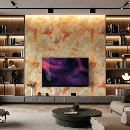 A modern living room with a large TV mounted on Landmark Decor’s Aurora Copper Marble Durable PVC Wall, built-in shelves with books and decor, and a round coffee table in front.