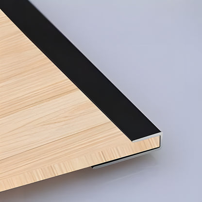 Close-up of the PVC Wall L Shape Strip by Landmark Decor: light wood panel corner with black metal trim, highlighting panel edges and wall accessories against a smooth, light-colored background.