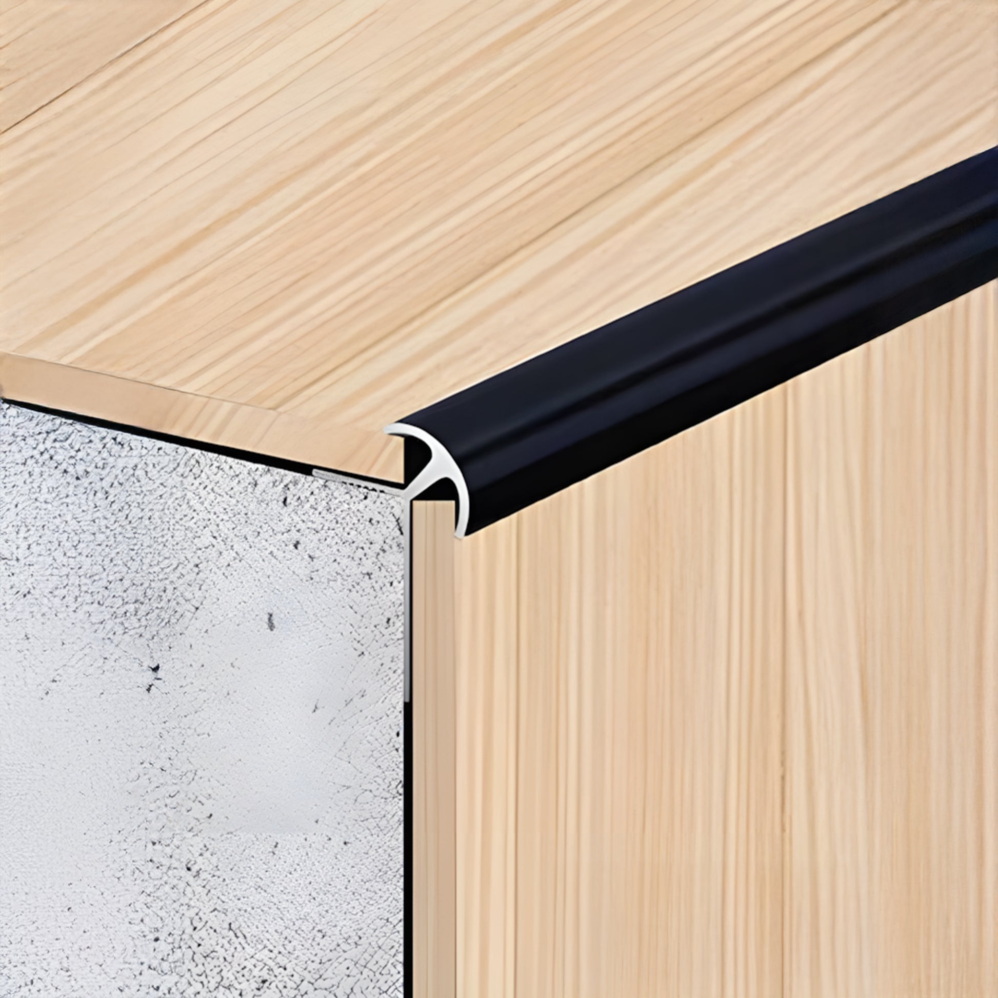 Close-up of panel edges with Landmark Decor’s PVC Wall Outer Corner Strip in black, highlighting the join between wood surface, trim, and composite core—perfect for wall panel installations.