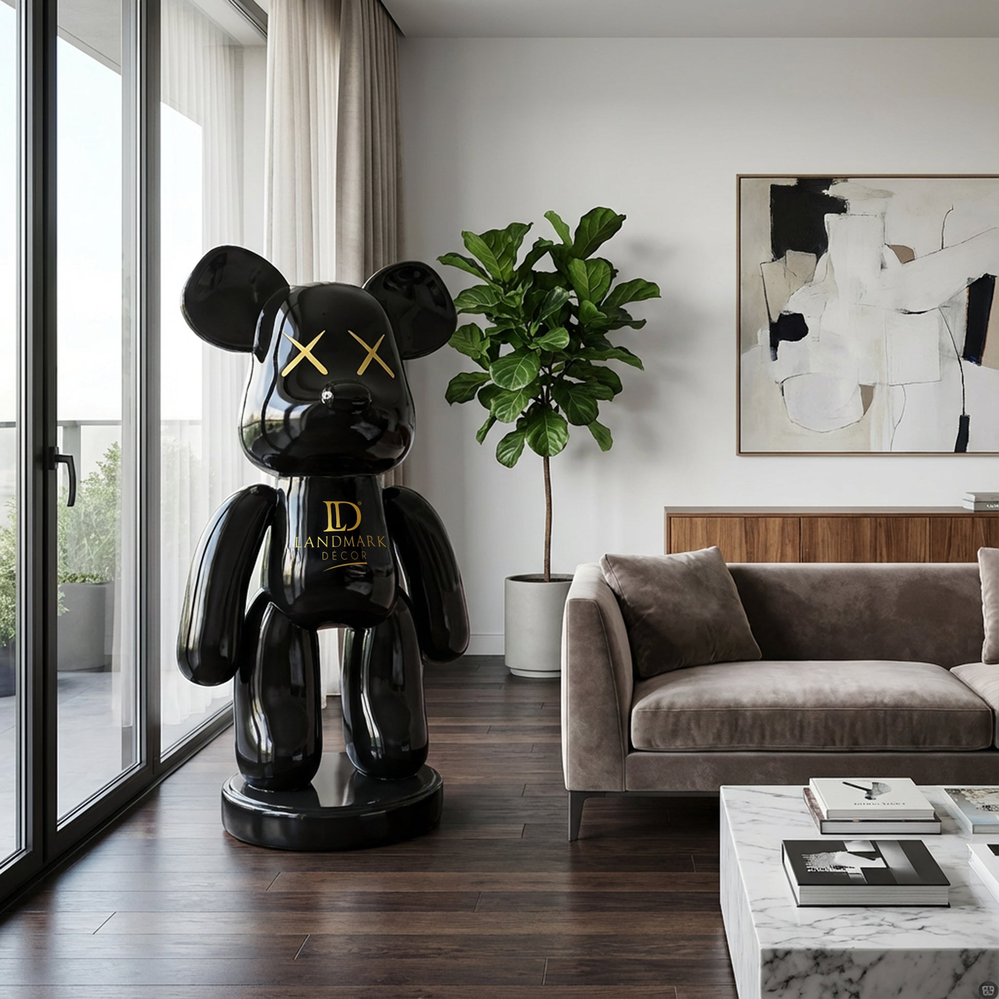 A modern living room featuring Landmark Decor’s Black Bear - Large sculpture, a gray sofa, potted plant, abstract painting, and a marble coffee table with books.