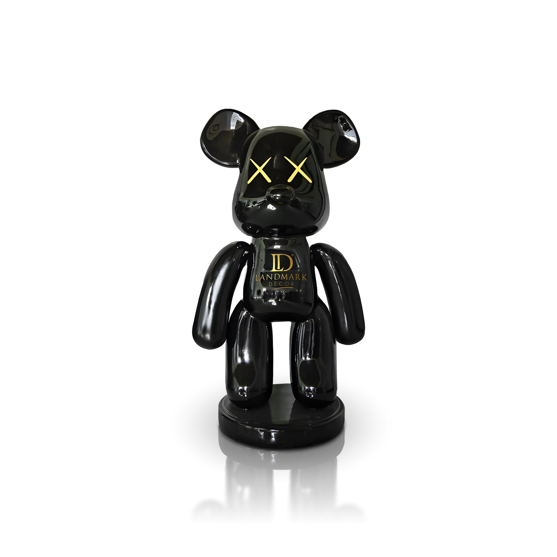 The Black Bear - Large by Landmark Decor features a glossy black bear shape with yellow X eyes and "Landmark" on its chest, standing on a round base—an ideal addition to your artistic sculpture or Landmark Decor collection.