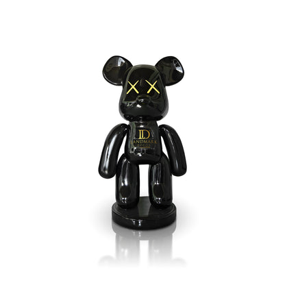 The Black Bear - Large by Landmark Decor features a glossy black bear shape with yellow X eyes and "Landmark" on its chest, standing on a round base—an ideal addition to your artistic sculpture or Landmark Decor collection.
