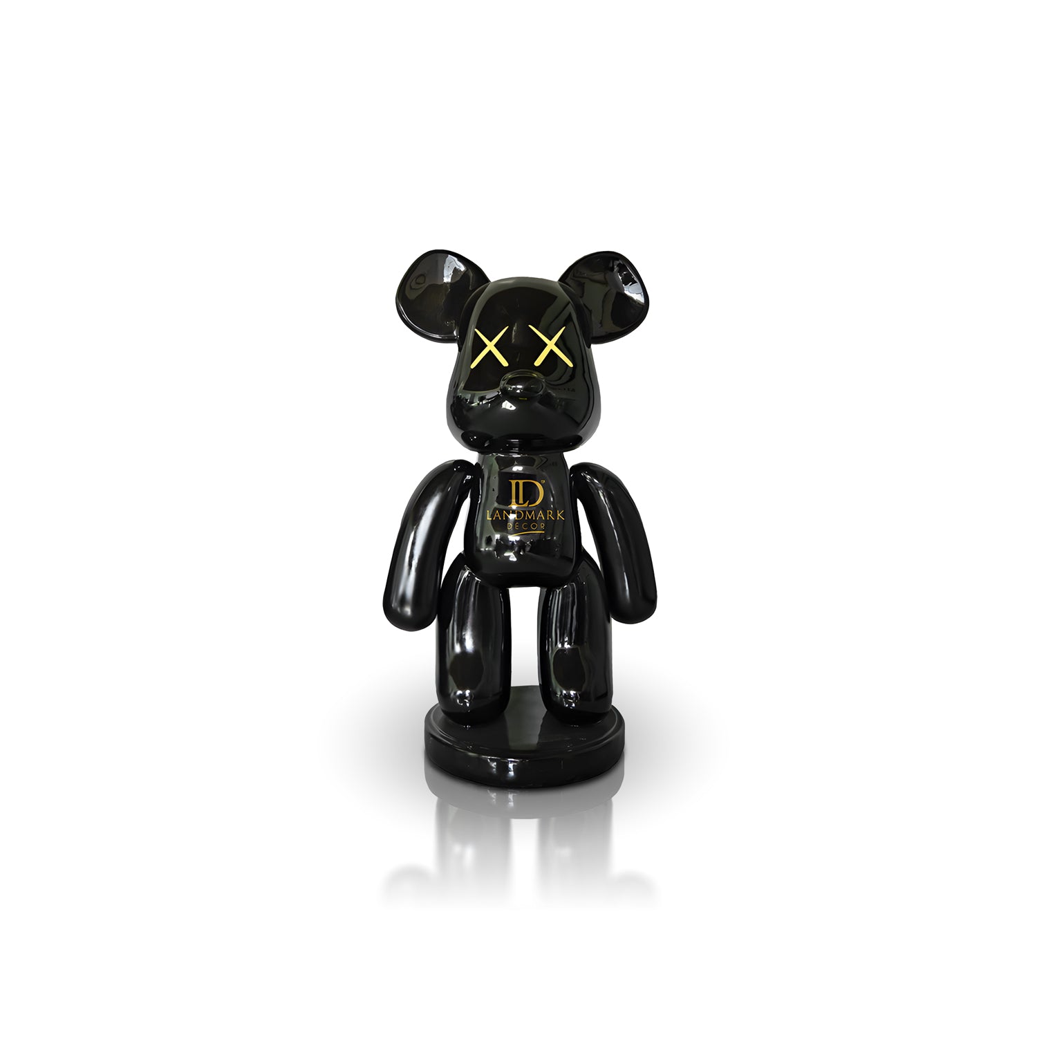 The Landmark Decor Black Bear - Medium is a glossy black bear figurine with yellow X eyes and gold LD Landmark on its chest, making a bold statement in your home when displayed on a white background.
