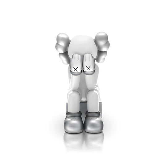 Veiled Thoughts - Electroplated by Landmark Decor features a gray and white cartoon figure with its head down, hands covering its face, and X marks on the hands—an artistic sculpture perfect for standout interior decor.