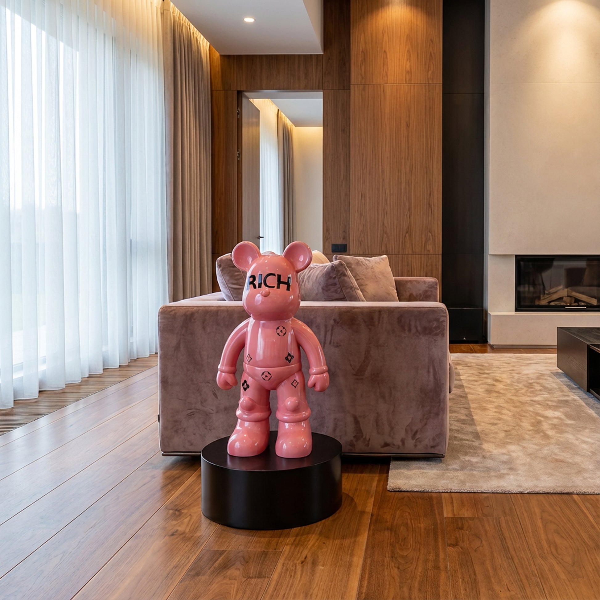 The Landmark Decor Rich Bear, a pink bear sculpture labeled "RICH" on a black pedestal, adds a bold artistic touch to interiors with its modern design—making it the perfect accent for stylish living rooms.