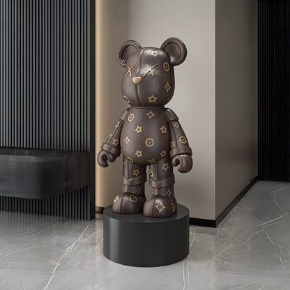 The Brown Bear by Landmark Decor is a large bear-shaped sculpture with a dark brown patterned surface on a round black pedestal, making a bold statement and elevating minimalist modern interiors.
