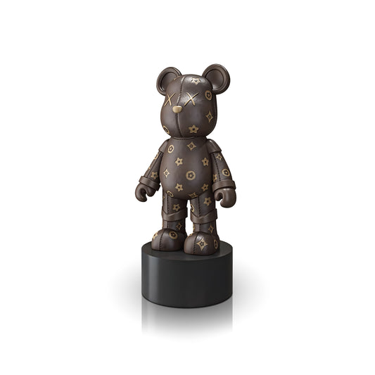 The Landmark Decor Brown Bear is a charming bear-shaped figurine with gold star and flower designs on a brown surface, set on a round black pedestal—an enchanting accent to enhance any room’s décor.
