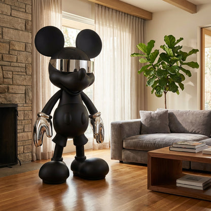 The Landmark Decor "Stay Cool" sculpture, a black artistic figure with metallic gloves and visor, brings unique style to any modern living room near a gray sofa and wooden floors.