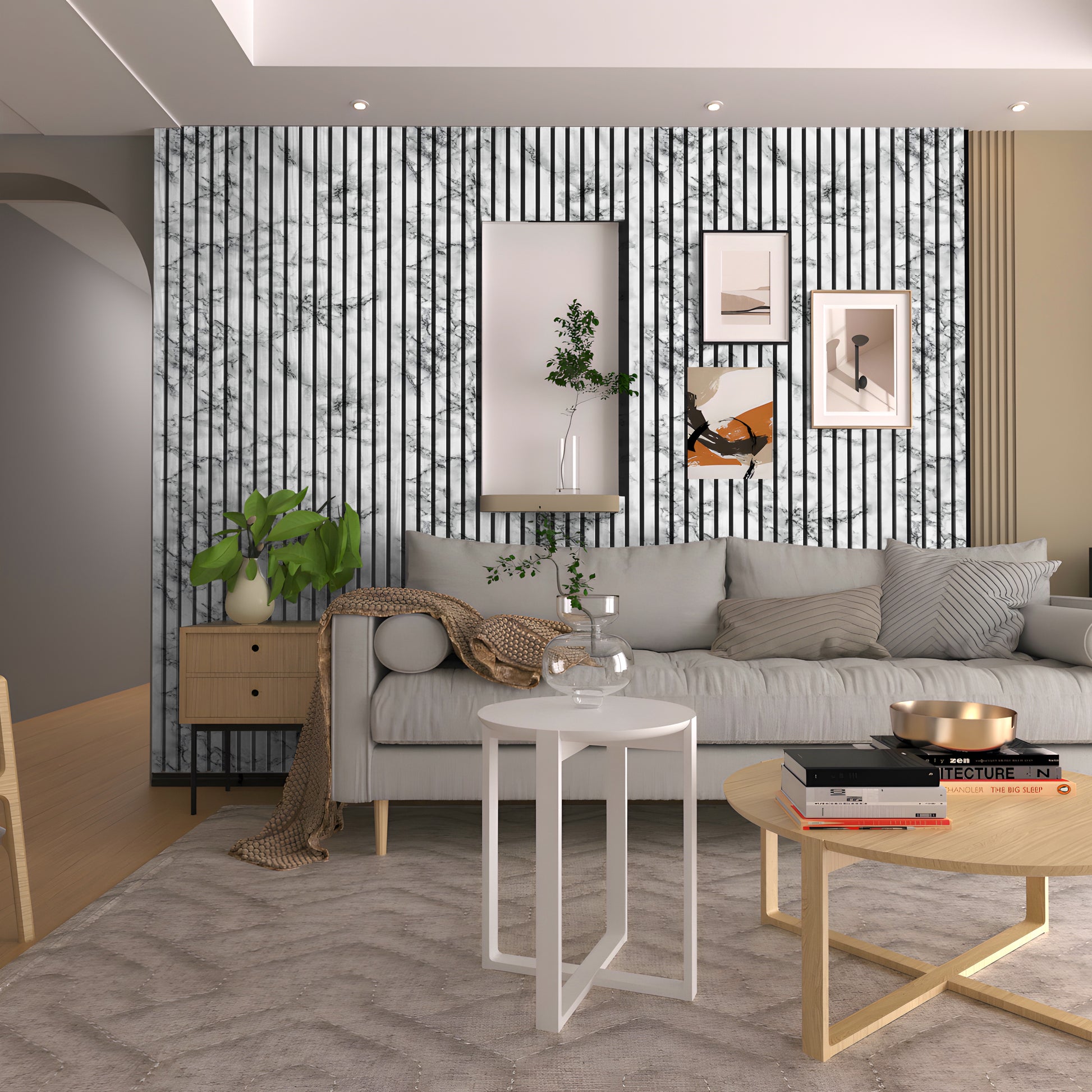 Modern living room featuring a gray sofa, decorative cushions, round coffee tables, wall art, and a striking Landmark Decor White Marble WPC Fluted Slat Wall Panel as an accent. A cabinet with plants sits beside the sofa.