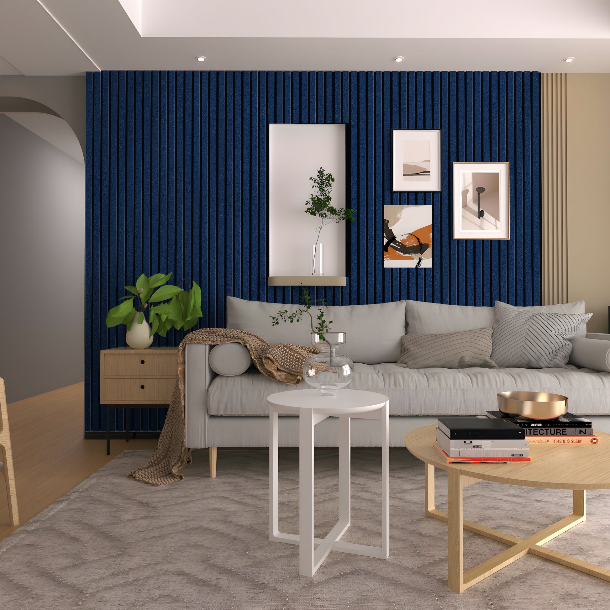 Modern living room featuring a gray sofa, round coffee tables, plants, and framed art on Landmark Decor’s Navy Blue Frosted Effect Slat Wall Panel. Neutral furnishings complement the striking wall accent.