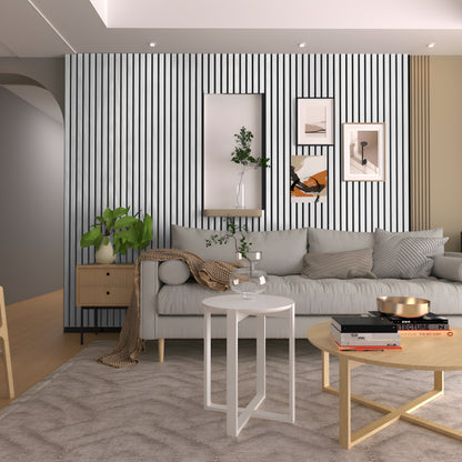 Modern living room featuring a grey sofa, Landmark Decor Tany Grey WPC Fluted Slat Wall Panel, framed artwork, potted plant, and round coffee tables with decor on a light rug.